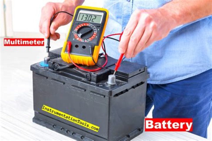 How do you check battery charging with a multimeter?